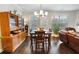 Dining area features a chandelier, natural light, and is connected to the living room at 2882 Cadence Walk Rd, Atlanta, GA 30360