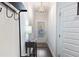 Bright hallway with hardwood floors, modern lighting, and a coat rack at 2882 Cadence Walk Rd, Atlanta, GA 30360