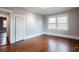 Bedroom with hardwood floors, white trim, and a door leading to another room at 3344 Dogwood Dr, Atlanta, GA 30354