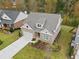 Aerial shot of home showcasing well-manicured lawn, brick exterior, and adjacent neighborhood at 3750 Montebello Pkwy, Cumming, GA 30028