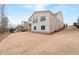 Expansive backyard with gentle slope featuring rear home elevation of the house with a brick facade at 3750 Montebello Pkwy, Cumming, GA 30028