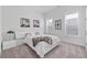 A modern bedroom with white walls, plush carpeting, and a comfortable-looking bed with throw blanket at 3750 Montebello Pkwy, Cumming, GA 30028