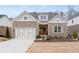 Charming brick home with a well-manicured lawn, two-car garage, and inviting front porch at 3750 Montebello Pkwy, Cumming, GA 30028