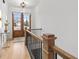 Elegant hallway with hardwood floors, staircase with black iron railing and wood trim at 3750 Montebello Pkwy, Cumming, GA 30028