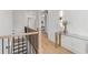 Bright hallway featuring hardwood floors, a glass console table and staircase with black iron railing at 3750 Montebello Pkwy, Cumming, GA 30028