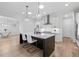 Bright kitchen with a large island, hardwood floors, and modern pendant lighting and breakfast bar seating at 3750 Montebello Pkwy, Cumming, GA 30028
