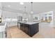 Modern kitchen with stainless steel appliances, an island with dark cabinets and white countertops and hardwood floors at 3750 Montebello Pkwy, Cumming, GA 30028