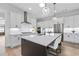 Open kitchen featuring an island with a black countertop, pendant lights, and stainless steel appliances at 3750 Montebello Pkwy, Cumming, GA 30028