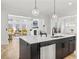 Open concept kitchen with large island, modern appliances, and a connected living room with ample natural light at 3750 Montebello Pkwy, Cumming, GA 30028