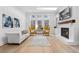 Inviting living room featuring a fireplace, hardwood floors, large windows, and comfortable seating arrangement at 3750 Montebello Pkwy, Cumming, GA 30028