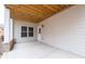 Covered patio area with concrete flooring and white siding, offering a private outdoor space at 3750 Montebello Pkwy, Cumming, GA 30028