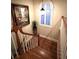 Well-lit staircase with wooden steps and white spindles, brightened by a shuttered window at 962 Manor Parc Dr, Decatur, GA 30033