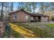 Outside angle shot of stone and wood paneled house on grassy lawn at 1350 Piedmont Rd, Marietta, GA 30066