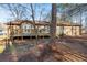 Back of house with an expansive wooden deck and views of a large, wooded backyard at 1350 Piedmont Rd, Marietta, GA 30066