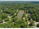 Aerial shot showcasing the lush greenery and lake surrounding the homes in the area at 1602 Windsor Walk, Avondale Estates, GA 30002