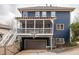 Back exterior features a garage, basketball hoop, and screened porch on the second level at 1602 Windsor Walk, Avondale Estates, GA 30002