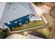 Aerial shot of the backyard with a privacy fence, lush grass, and mature trees at 1602 Windsor Walk, Avondale Estates, GA 30002