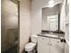 Tiled bathroom features a glass enclosed shower and white vanity with dark countertop at 1602 Windsor Walk, Avondale Estates, GA 30002