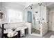 Luxury bathroom featuring a glass shower, freestanding tub, and modern fixtures at 1602 Windsor Walk, Avondale Estates, GA 30002