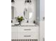 Bathroom featuring dual sinks, white subway tile, two oval mirrors, and tasteful decor at 1602 Windsor Walk, Avondale Estates, GA 30002