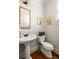 Elegant powder room with a classic pedestal sink and beautiful mirror at 1602 Windsor Walk, Avondale Estates, GA 30002