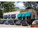 Banjo Coffee building with blue awnings and street parking in front at 1602 Windsor Walk, Avondale Estates, GA 30002
