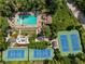 Overhead aerial view of the community pool and tennis courts with surrounding trees at 1602 Windsor Walk, Avondale Estates, GA 30002