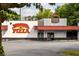 Exterior shot of Savage Pizza with clear signage and accessible entrance at 1602 Windsor Walk, Avondale Estates, GA 30002