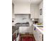Modern kitchen with stainless steel appliances, white countertops, and ample cabinet space at 1602 Windsor Walk, Avondale Estates, GA 30002