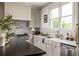 Bright kitchen with white cabinets, black countertops, and stainless steel appliances at 1602 Windsor Walk, Avondale Estates, GA 30002