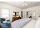 Comfortable bedroom offering natural light, a cozy armchair, and doorway to bath at 1602 Windsor Walk, Avondale Estates, GA 30002