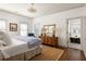 A peaceful bedroom showcasing hardwood floors, a plush bed, and an adjacent bathroom at 1602 Windsor Walk, Avondale Estates, GA 30002