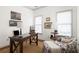 A well-lit home office features a stylish desk, patterned armchair, and nautical-themed decor at 1602 Windsor Walk, Avondale Estates, GA 30002