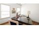 A well-lit home office features a stylish desk, patterned armchair, and nautical-themed decor at 1602 Windsor Walk, Avondale Estates, GA 30002