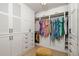 A spacious walk-in closet offers ample storage with custom shelving, cabinets, and organized clothing racks at 1602 Windsor Walk, Avondale Estates, GA 30002