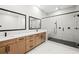 Modern bathroom with a double vanity, a glass-enclosed shower, and sleek fixtures at 3462 Dryden Se Ln, Vinings, GA 30339