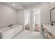 Luxurious bathroom with a soaking tub, marble floors, and a separate vanity at 3462 Dryden Se Ln, Vinings, GA 30339