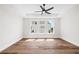 Sun-filled bedroom with a tray ceiling, large windows, and hardwood floors at 3462 Dryden Se Ln, Vinings, GA 30339