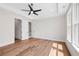 Bright bedroom featuring a tray ceiling, hardwood floors, recessed lighting, and access to an ensuite bath at 3462 Dryden Se Ln, Vinings, GA 30339