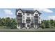 Beautiful three-story townhome with brick and stucco facade, black trim and a modern design at 3462 Dryden Se Ln, Vinings, GA 30339