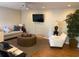 Cozy living room featuring hardwood floors, a plush sofa, and a modern TV for relaxation at 4033 Louise St, Powder Springs, GA 30127