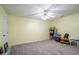 Bonus room with neutral carpet, ceiling fan, and closet; ideal for recreation or storage at 4779 Longcourt Dr # 21, Atlanta, GA 30339