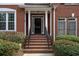 Beautiful red brick townhome with black door and columns at 4779 Longcourt Dr # 21, Atlanta, GA 30339