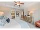 Beautiful bedroom with tray ceiling, neutral walls, and view into bathroom at 320 Navigator Ln, Mcdonough, GA 30253