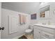 Small, all-white bathroom with vanity, mirror, and coordinated fixtures at 1650 Old Loganville Rd, Loganville, GA 30052