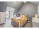 Bedroom with sloped ceilings, carpet, and a bed with a white metal frame at 1650 Old Loganville Rd, Loganville, GA 30052
