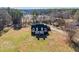 Expansive aerial view of a two-story home with a charming front porch and meticulously maintained lawn at 1650 Old Loganville Rd, Loganville, GA 30052