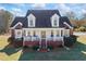 Charming two-story brick home with a covered front porch and manicured landscaping at 1650 Old Loganville Rd, Loganville, GA 30052