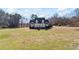 Classic red brick home featuring a welcoming white porch and set on a spacious lawn at 1650 Old Loganville Rd, Loganville, GA 30052