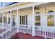 Charming front porch with white columns, rocking chairs, and beautiful architectural details at 1650 Old Loganville Rd, Loganville, GA 30052